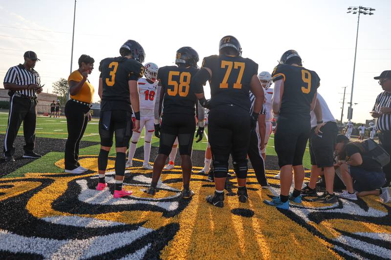 Joliet West and Shepard stand at midfield for the coin toss on Friday, Aug. 25, 2023 in Joliet.