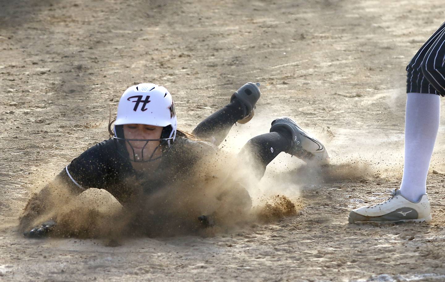 Huntley's Piper Heimbrodt slides into home plate to score a run during a Fox Valley Conference softball game against Crystal Lake Central on April 7, 2026, at Crystal Lake Central High School.