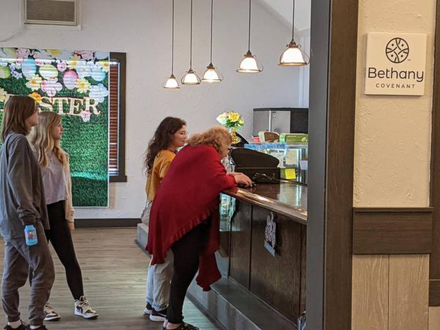 Those attending Sunday's Easter service at Bethany Covenant Church in St. Charles stand in line to get something to eat at Dimple's Donuts. Bethany Covenant Church is located inside Dimple's Donuts