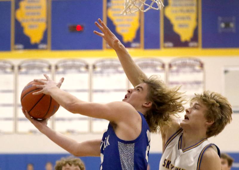 Woodstock’s Jackson Lyons drives to the basket against Johnsburg's Dylan Schmidt during a Kishwaukee River Conference boys basketball game Tuesday, Jan. 31, 2023, at Johnsburg High School.