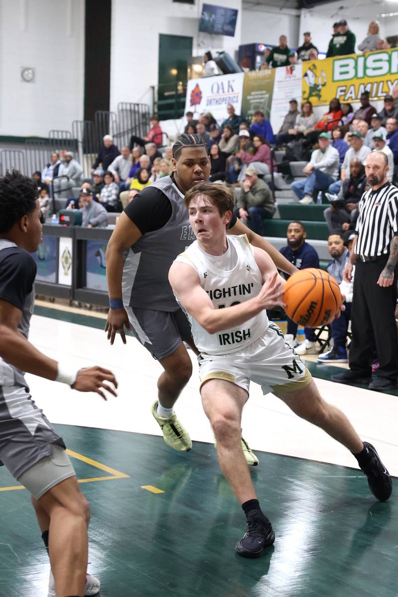 Bishop McNamara's Teddy Fogel looks to pass on the run during the Fightin' Irish's 70-51 loss to Hope Academy on Tuesday, Dec. 9, 2025