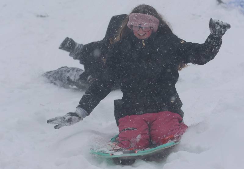 Mila tieman of Peru, sleds down the large hill on Saturday, Nov. 29, 2025 at McKinley Park in Peru.