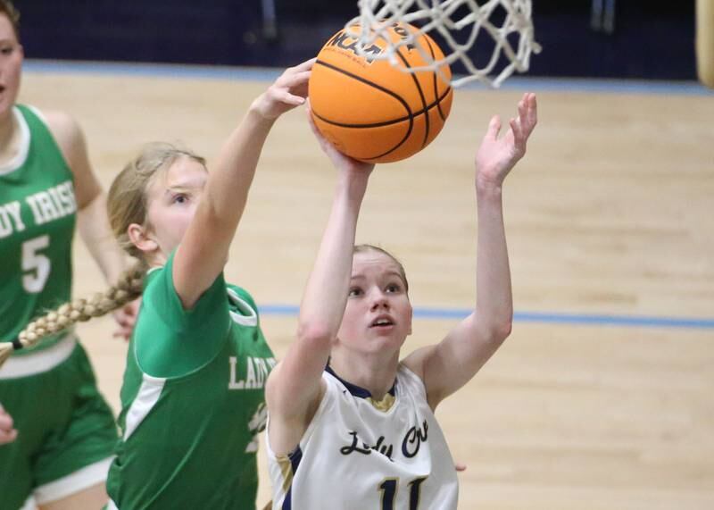 Seneca's Graysen Provance blocks Marquette's Keely Nelson's shot on Thursday, Dec. 5, 2024 in Bader Gym at Marquette High School.