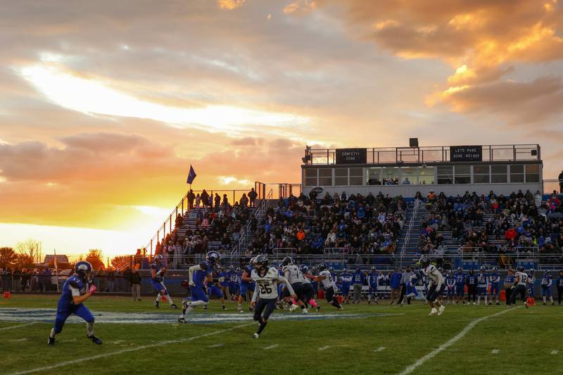 The sun sets as Clifton Central runs an offensive play during the Comets' 24-6 victory over Knoxville in the Class 1A first-round playoff game on Saturday, Nov. 1, 2025.