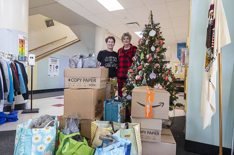 Jefferson School staff members Sara Faley (left) and Jodi Wolf show off over 700 items of food, gloves and hats that were donated by students and staff as a way to give back, The non-perishable food items will be give to the food bank and the gloves and hats will be shared with students in all of Dixon’s schools. Classes competed with their raised donations. First place receives a pizza party, with second and third being treated to donuts.