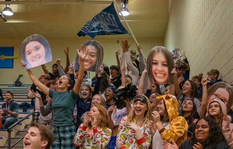 Oswego East's fans celebrate after their team wins the first set against Neuqua Valley during the Neuqua Valley 4A regional final volleyball match at Neuqua Valley High School in Naperville on Thursday, Oct 27, 2022.