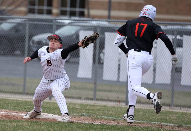 DeKalb's Paul Kakoliris stretches for the throw to get Harlem's Jackson Heidemann at first during their game Tuesday, April 1, 2025, at DeKalb High School.
