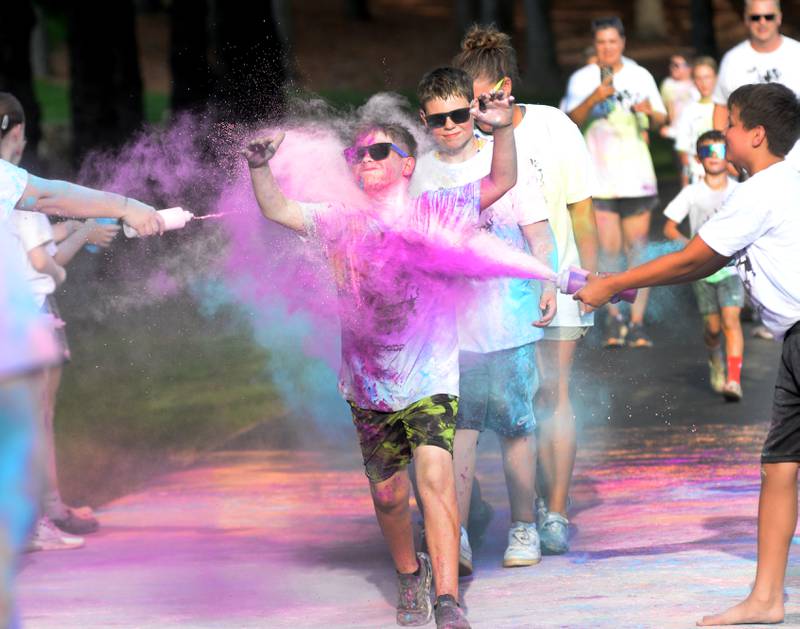 Griffin Sager, 10, of Oregon, runs through powder station during the Oregon Park District's Color Run on Tuesday, July 22, 2025 at Oregon Park West. Around 400 people took part in the evening event, held prior to the park district's final Concert in the Park.