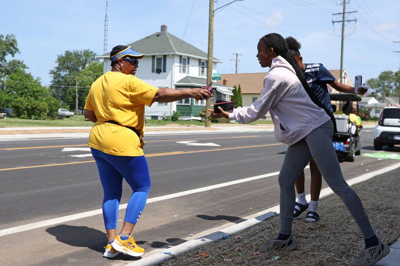 Diane Taylor hands out candy to spectators during the annual Kankakee Juneteenth Parade on Saturday, June 21, 2025.