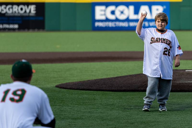 Minooka resident Dominic Hahn, of the Miracle League, throws out a first pitch at the home opener of the Joliet Slammers on Friday, May 8, 2026.