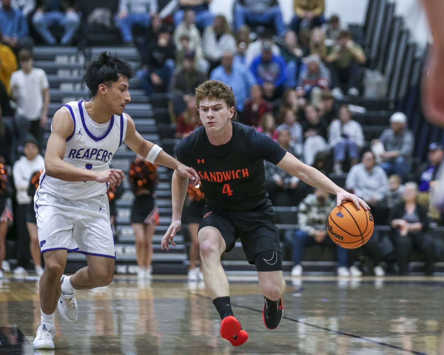 Sandwich's Griffin Somlock (4) drives past the defense of Plano's Alan Contreras (1) during their basketball game between Sandwich at Plano Tuesday, Dec 9, 2025 in Plano.