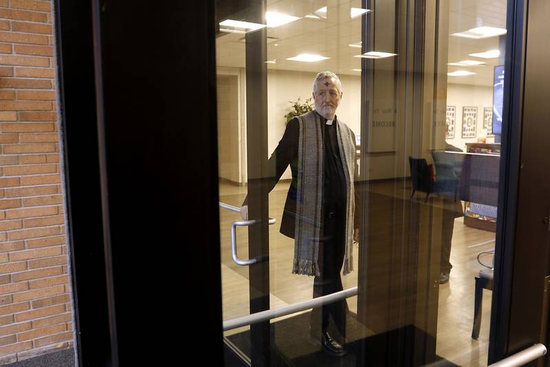 Rev. Jeffry Bross, the senior pastor at the United Methodist Church of Libertyville, waits out of the rain for people to arrive during a Drive-Thru Ash Wednesday Blessing on Wednesday, March 05, 2025, at the United Methodist Church of Libertyville. This was the first time the church has offered a Drive-Thru Ash Wednesday Blessing, that created a simple convenient way for individuals to receive ashes and mark the beginning of the Lenten season.
