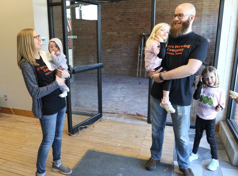 Founders of Byers Brewing Co., Steve and Megan Byers, along with their children, Amelia, 6 months, Kennedy, 4 and Lily, 6, give a tour March 26 of the space that will house their new brewery and bar on the first floor of the building at 230 E. Lincoln Highway in DeKalb.
