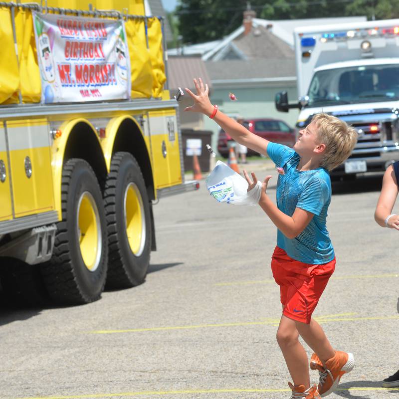 JD Ingersoll, 9, of Byron, tries to catch a piece of candy during the Let Freedom Ring parade on July 4.