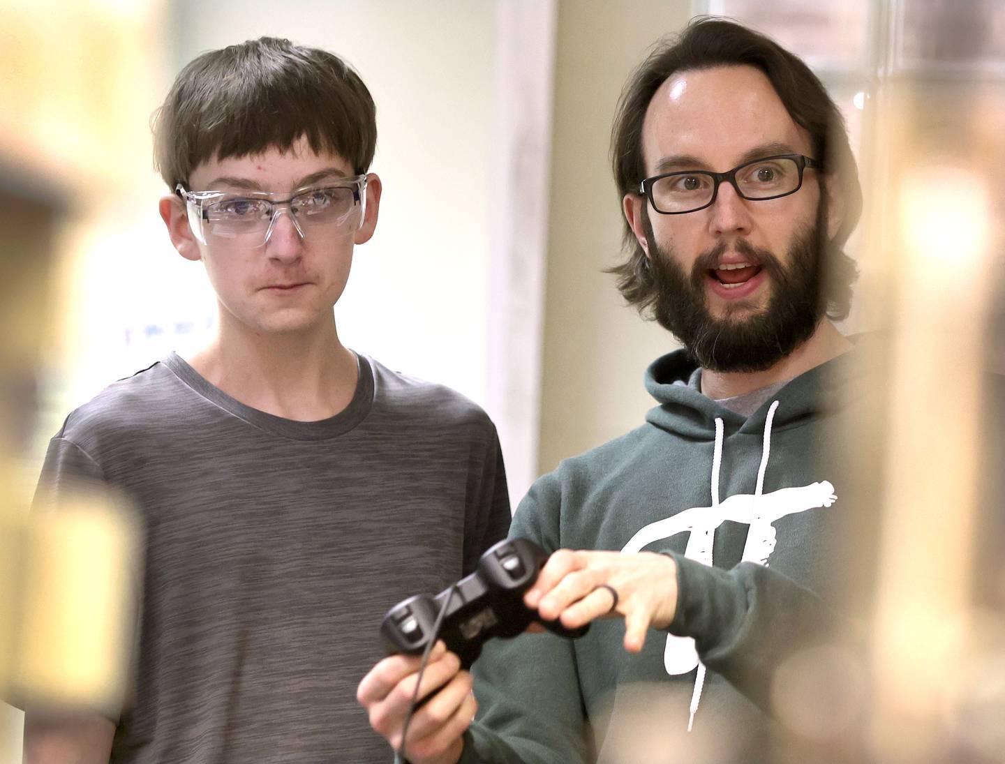 Michael Lofthouse, "Crowbotics" team faculty advisor and math teacher at DeKalb High School, along with freshman Blake Bollow run the team's robot through its paces Thursday, March 10, 2022, at Huntley Middle School in DeKalb. The team is preparing for a competition that begins in early April.
