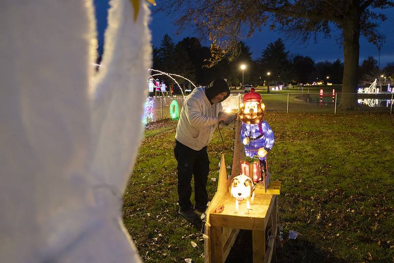 Kirk Spielman decorates a Rudolph themed scene for Community State Bank Tuesday, Nov. 26, 2024, at Centennial Park in Rock Falls. Rock Falls Tourism and the Coloma Township are teaming up once again for a drive through lighted tour in the park.