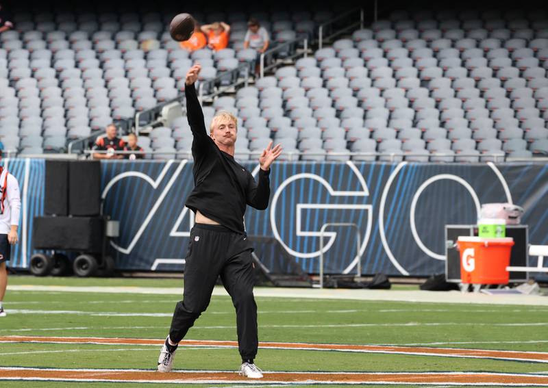 Former Northern Illinois University and current Cincinnati Bengals quarterback Rocky Lombardi loosens up before making his NFL debut Saturday, Aug. 17, 2024, at Soldier Field in Chicago. Lombardi checked in during the second half of a 27-3 loss to the Chicago Bears. Lombardi is competing for a roster spot with the Bengals.