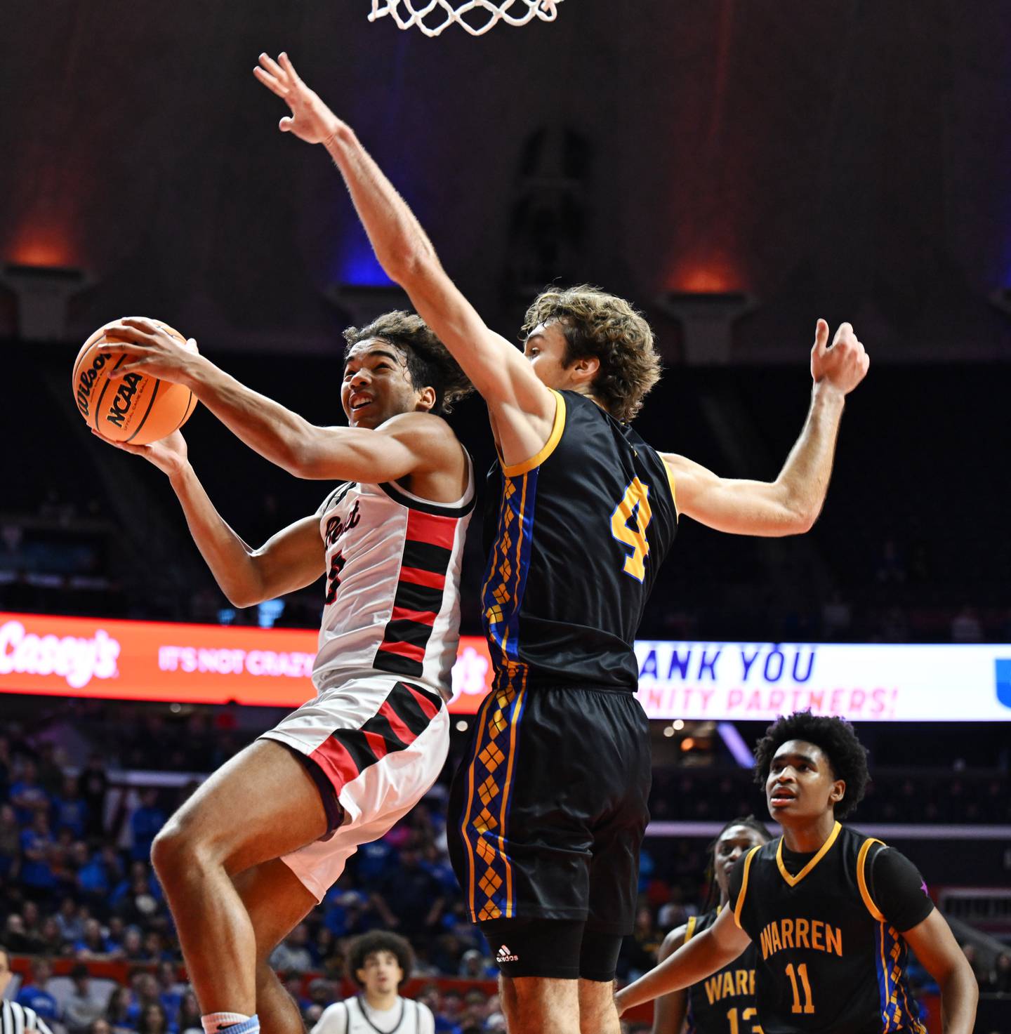 Benet Academy's Blake Fagbemi, left, tries to beat Warren's Jack Wolf to the basket during the IHSA Class 4A boys basketball state championship game at State Farm Center on Saturday, March 15, 2025 in Champaign.