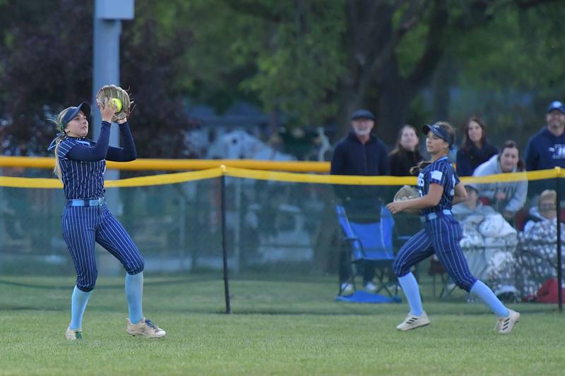 Downers Grove South’s Jacklyn Meyers makes a putout in center field as teammate Jordan Balsavich runs to back her up during a game against Downers Grove North on May 14, 2026 at McCollum Park in Downers Grove .