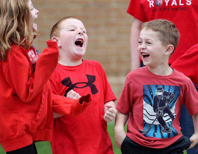 Students from Hinckley-Big Rock Elementary School cheer as a passing truck honks his horn Monday, May 5, 2025, outside of the school as they await the arrival of Marshall Morong, 7, a first grader, for his first day back following months waiting for, and eventually receiving, heart transplant surgery at Lurie Children’s Hospital of Chicago. Morong arrived in style in a Tesla Cybertruck donated for use by Telsa of Naperville, along with an escort by Hinckley and Big Rock first responders.