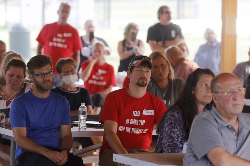 People listen to a speaker Wednesday, June 28, 2023, during a Stop the Pit Town Hall meeting at Veterans Park in McHenry. Over 150 people attend the town hall meeting to learn and voice their concerns about a proposed sand and gravel mining operation near McHenry.