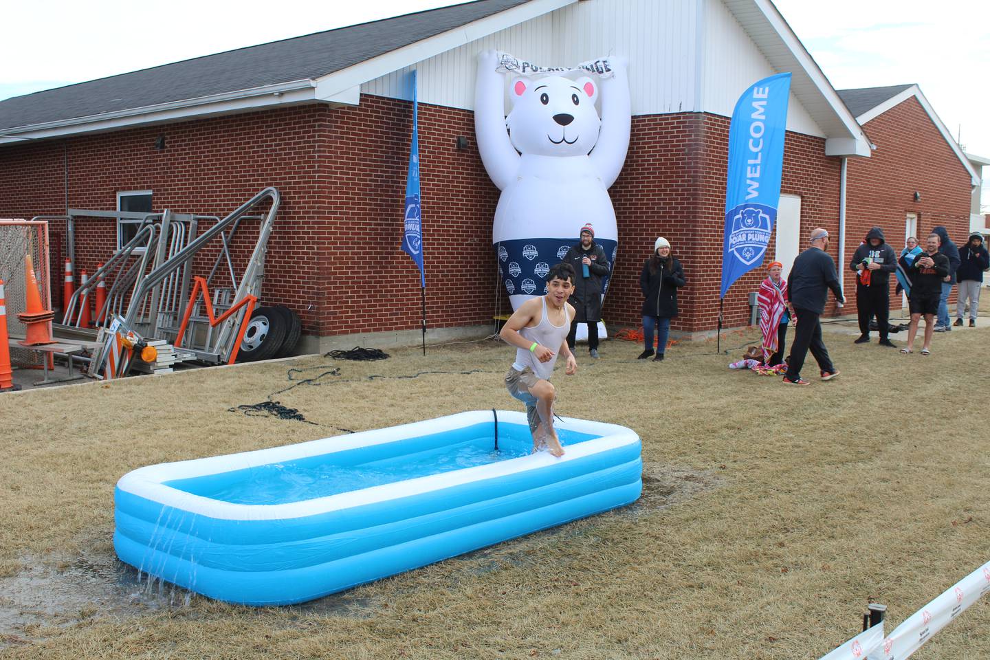 A plunger makes a splash into an inflatable pool during McHenry Community High School's first polar plunge on Feb. 1, 2025.