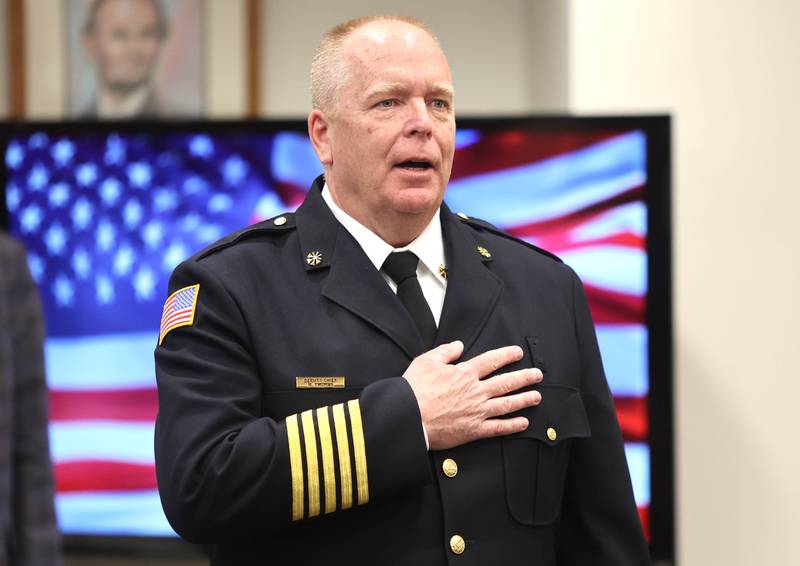 Acting DeKalb Fire Chief Michael Thomas leads the Pledge of Allegiance prior to being sworn in as the city's new full-time fire chief Monday, April 11, 2022, during the DeKalb City Council meeting at the library. Thomas has been serving as the acting chief since the retirement of former chief Jeff McMaster in November.