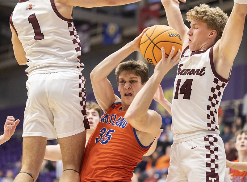 Eastland’s Parker Krugman looks to make a play against Tremont’s Josh Papenhause (left) and Griffin Meeker Monday, March 9, 2026, in the Class 1A Macomb Supersectional.
