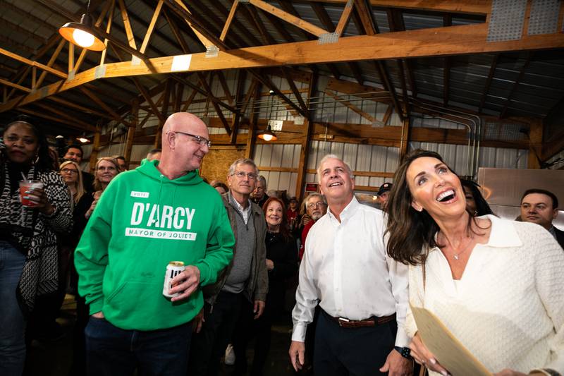 Terry D'Arcy, center and his wife Sue are all smiles as election results displayed on a TV show him with a lead, in Joliet, on Tuesday, April 4, 2023.