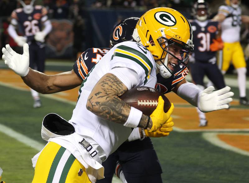 Green Bay Packers wide receiver Christian Watson gets past Chicago Bears cornerback Nick McCloud for a touchdown during their NFL Wild Card game Saturday, Jan. 10, 2026, at Soldier Field in Chicago.