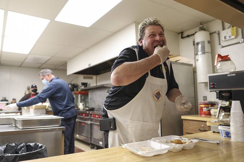 Bill Schelli, organizer of this year's fish fry, tastes the first batch of fried fish on Wednesday, Feb. 17, 2021, at St. Joseph Park in Joliet, Ill. St. Joseph Catholic Church made slight modifications to its annual fish fry this year, creating a drive-thru to maintain safe social distance for all diners.