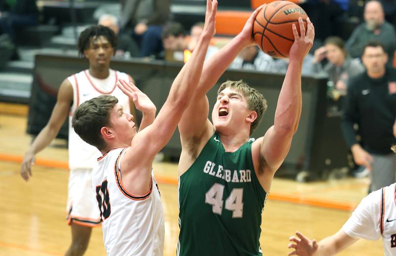 Glenbard West's Jack Oberhofer shoots over DeKalb's Eric Rosenow during their game Tuesday, Nov. 29, 2022, at DeKalb High School.