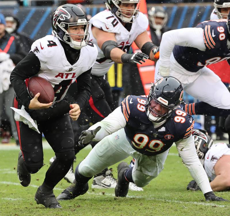 Chicago Bears defensive tackle Gervon Dexter Sr. dives for Atlanta Falcons quarterback Taylor Heinicke during their game Sunday, Dec. 31, 2023, at Soldier Field in Chicago.