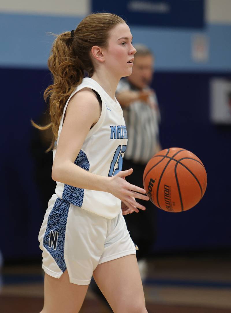 Nazareth's Mary Bridget Wilson (15) brings the ball up court during the girls varsity basketball game between Benet and Nazareth academies on Wednesday, Jan. 3, 2023 in La Grange Park, IL.