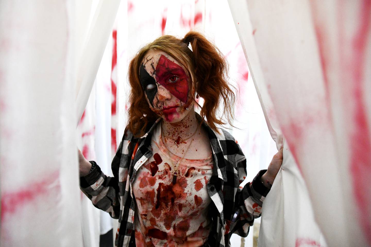Volunteer Lilyan Fehrenbacher, of St. Anne, poses for a photo in the Chebanse Haunted House ahead of opening night at the Chebanse Civic Center in 2022. "This is the best haunted house I've volunteered in, and the safest," said Fehrenbacher, a special effects makeup enthusiast who participates with her grandfather.