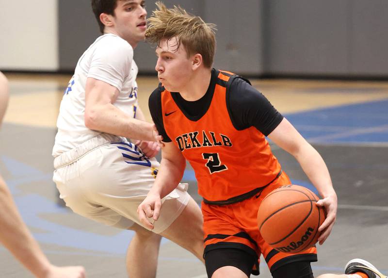 DeKalb’s Sean Reynolds drives by Lyons Township's Max Hoffmann Monday, Jan. 15, 2023, during their game in the Burlington Central Martin Luther King Jr. boys basketball tournament.