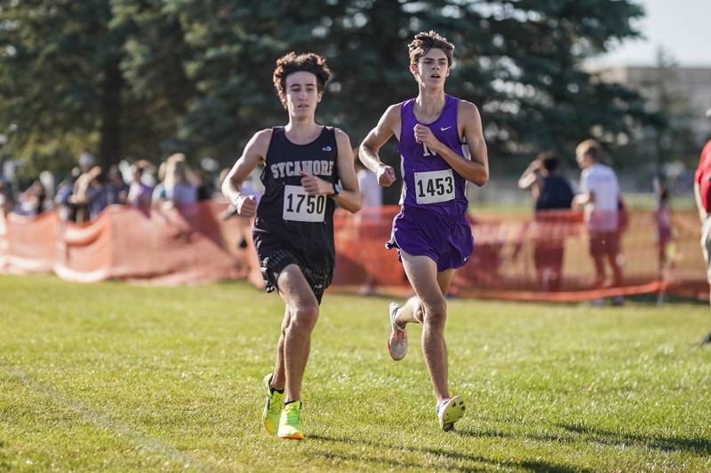 Sycamore’s Corey Goff and Downers Grove North’s Colin Finn compete make their way to the finish line in the Eddington cross country invitational at Kaneland High School in Maple Park on Saturday, Sep 21, 2024.