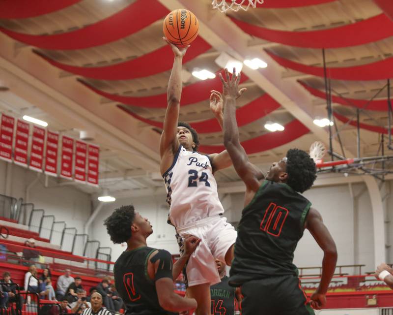Oswego East's Dshaun Bolden (24) puts up a shot at the basket during their Hinsdale Central Holiday Classic basketball game between Morgan Park at Oswego East Saturday, Dec 27, 2025 in Hinsdale.