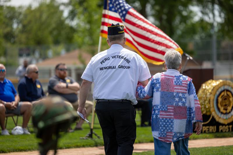 (left to right) Dennis Znaniecki of the Peru Honor Guard walks with Kathy Ankiewicz at the annual Memorial Day service on Monday, May 26, 2025 at Washington Park in Peru.