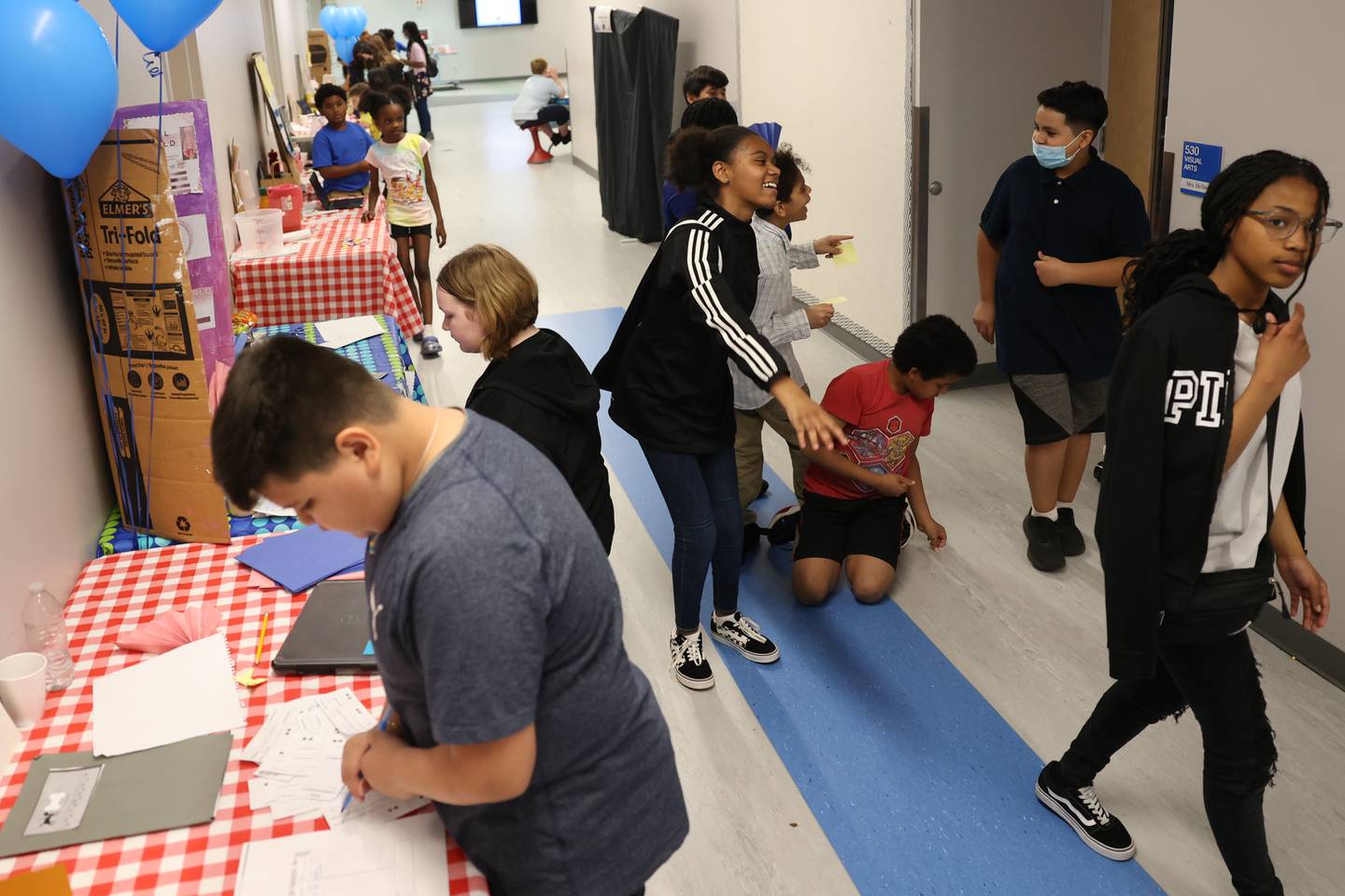 Students browse the various business booths set up at the Laraway 70C 5th Grade Business Expo. Friday, May 13, 2022, in Joliet.