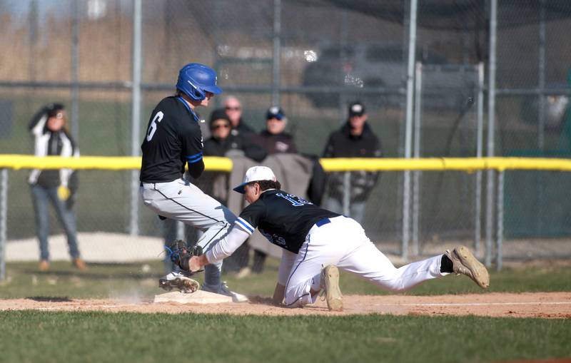 Burlington Central’s Connor Finn (right) tries to get St. Charles North’s Keaton Reinke out at third during a game on Tuesday, April 8, 2025 at Burlington Central.