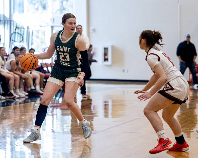 Lili McClain (23) of St. Bede dribbles ball as Hall's Bernadette Larsen (15) defends on Saturday, January 31, 2026 at Hall High School in Spring Valley.