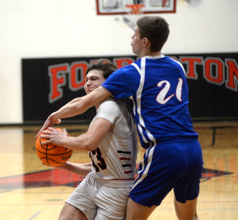 Forreston's Kendall Erdmann (13) drives to the basket and is fouled by Oregon's Tucker O'Brien during a Saturday, Jan. 25, 2025 game at Forreston High School.