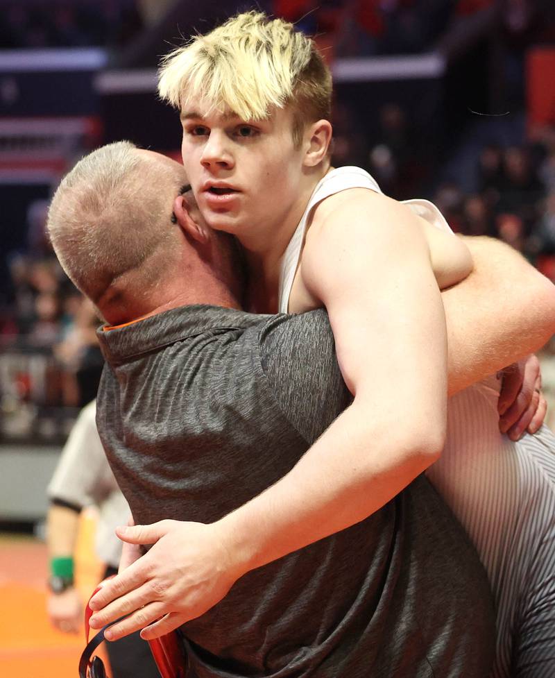 Fulton’s Zane Pannell and his coach celebrate his win over Unity’s Kyus Root Saturday, Feb. 18, 2023, in the Class 1A 170 pound 3rd place match in the IHSA individual state wrestling finals in the State Farm Center at the University of Illinois in Champaign.