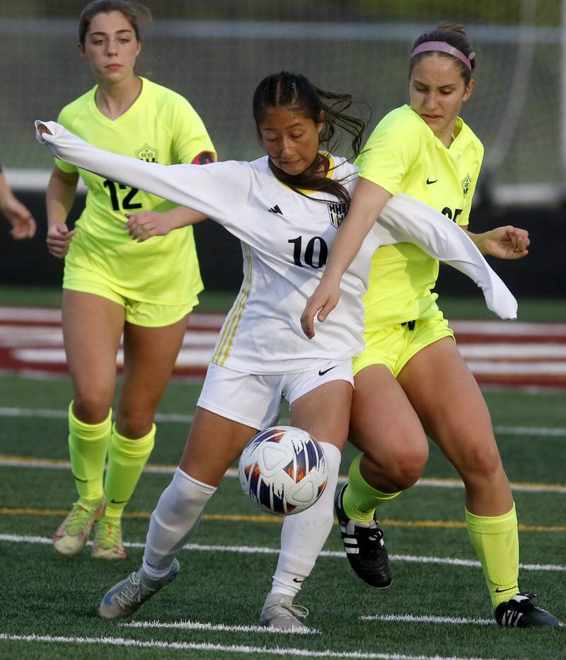 Harvard's Liz Aquino battles with Richmond-Burton's Nadia Layer for control of the ball during the Kishwaukee River Conference Girls Soccer Tournament Championship Match on Wednesday, May 7, 2025, at HRichmond-Burton High School in Richmond.