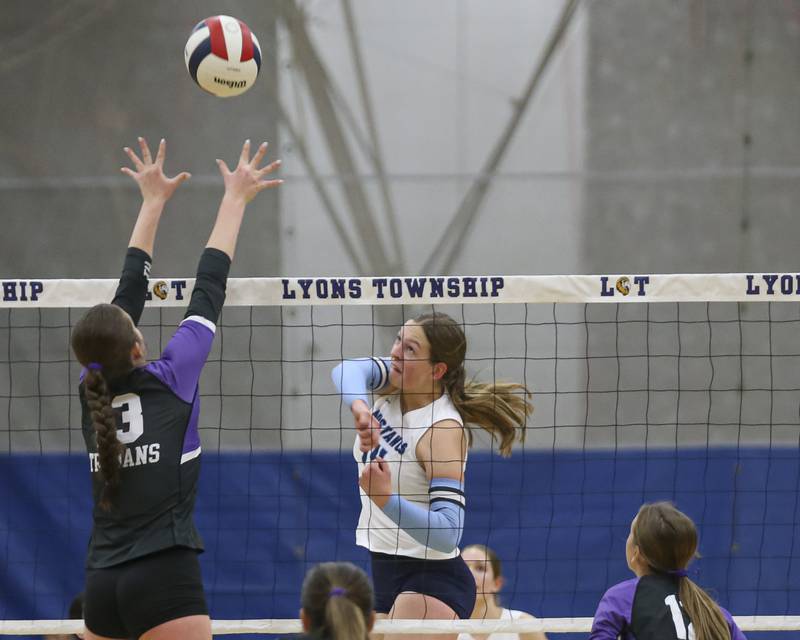 Downers Grove South's Jennifer Curran (14) spikes the ball over the net during Class 4A Lyons Sectional Semifinal volleyball match between Downers Grove South at Downers Grove North. Nov 4, 2025 in La Grange.