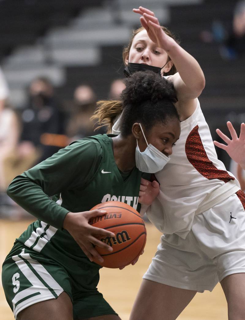 Crystal Lake South's Kree Nunnally pushes into McHenry defender Alyssa Franklin during their game on Tuesday, January 11, 2022 in McHenry.