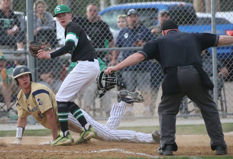 Marquette's Charlie Mullen is called safe while sliding into home from a pass ball as Seneca pitcher Max Giertz misses the tag on Wednesday, April 19, 2023 in Ottawa.