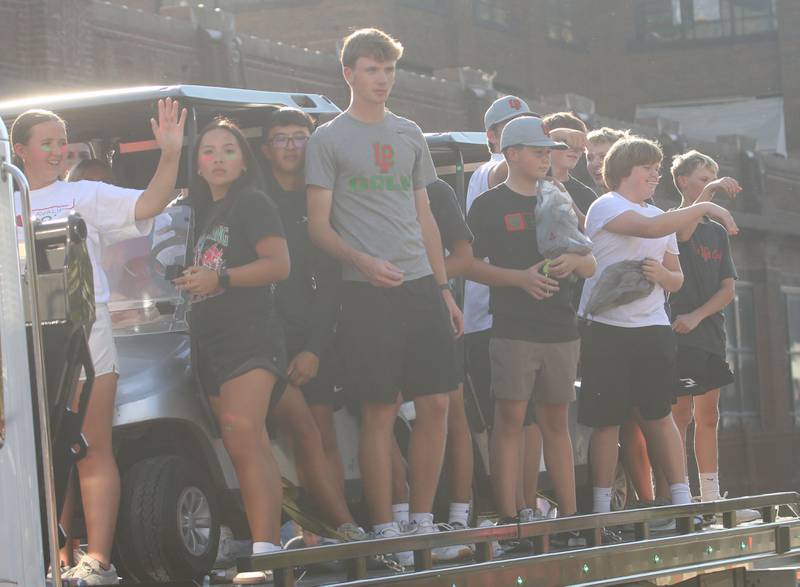 The L-P boys and girls golf team ride on a float during the L-P homecoming parade on Thursday, Oct. 2, 2025 downtown Peru.
