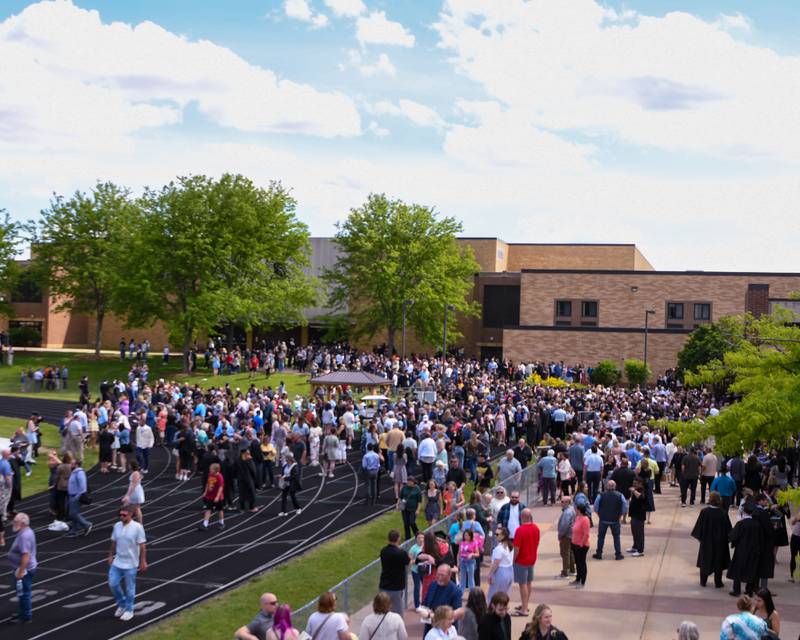 Sycamore graduates look for loved ones outside the school on Sunday, May 25, 2025, during the Class of 2025 Commencement ceremony at Sycamore High School.